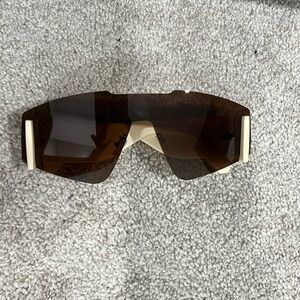 No brand name sunglasses. Brown tint. Cream colored side frames. Never worn